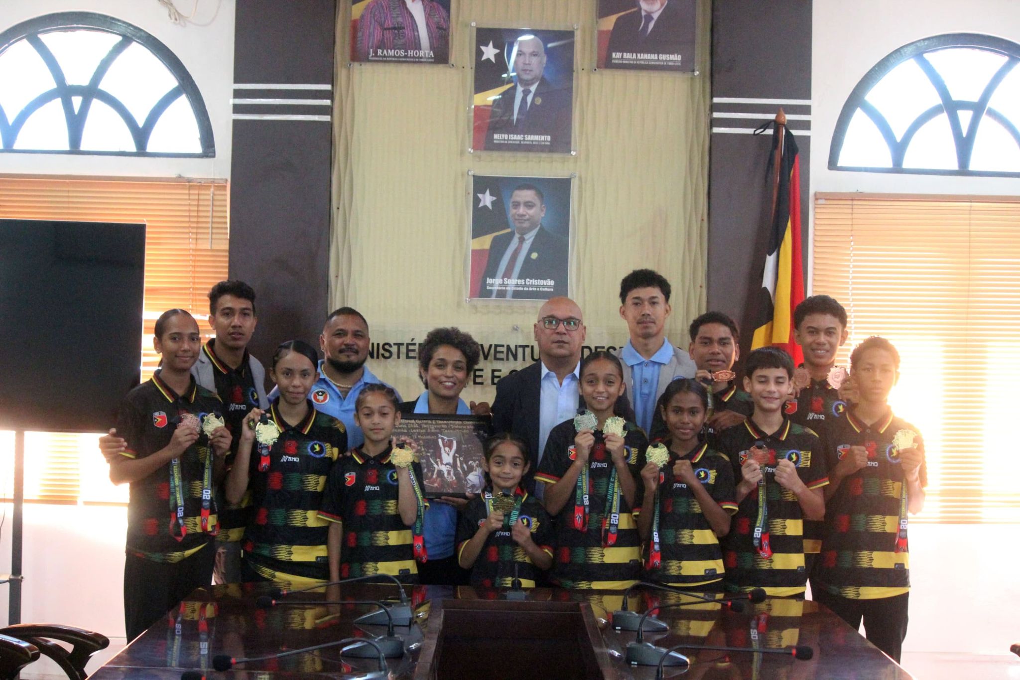 Neymia and fellow taekwondo athletes holding their medals with officials