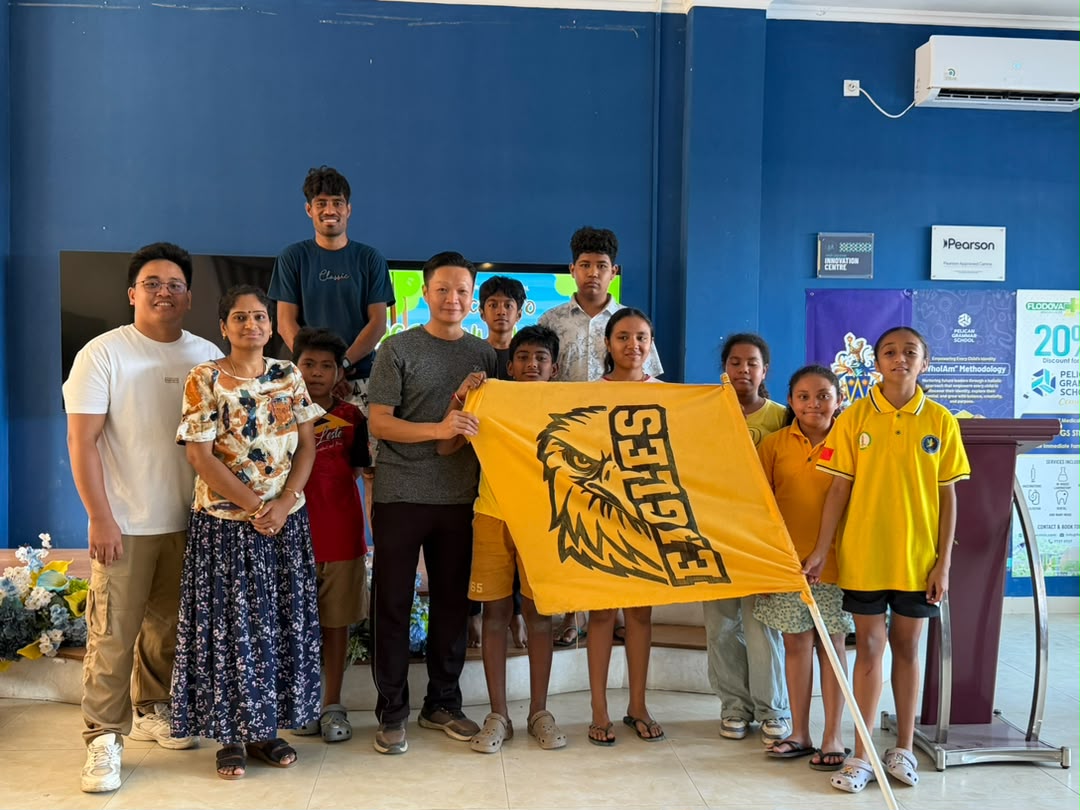 A team holding a yellow flag and certificate at the camp closing ceremony